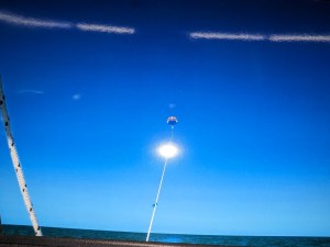Parasailing over the clear blue water of Marco Island with sweeping coastal views below